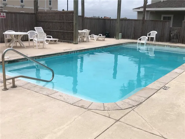 a view of a swimming pool with a lounge chairs