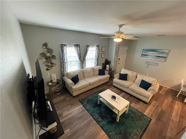 a living room with furniture and a chandelier