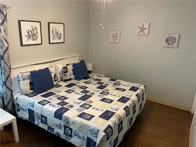 a bedroom with a bed and a lamp