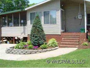 139 Crestview Street Rutherfordton, NC 28139 - Photo 2 of 6 a view of house with a yard and a bench