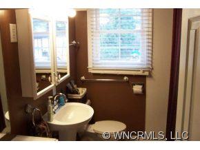 139 Crestview Street Rutherfordton, NC 28139 - Photo 4 of 6 a bathroom with a sink toilet and mirror