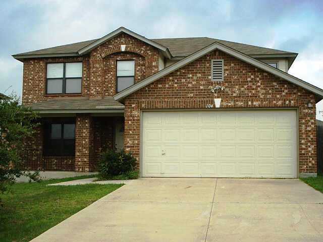 104 Vicksburg Loop Elgin, TX 78621 - Photo 1 of 1 a front view of a house with garden
