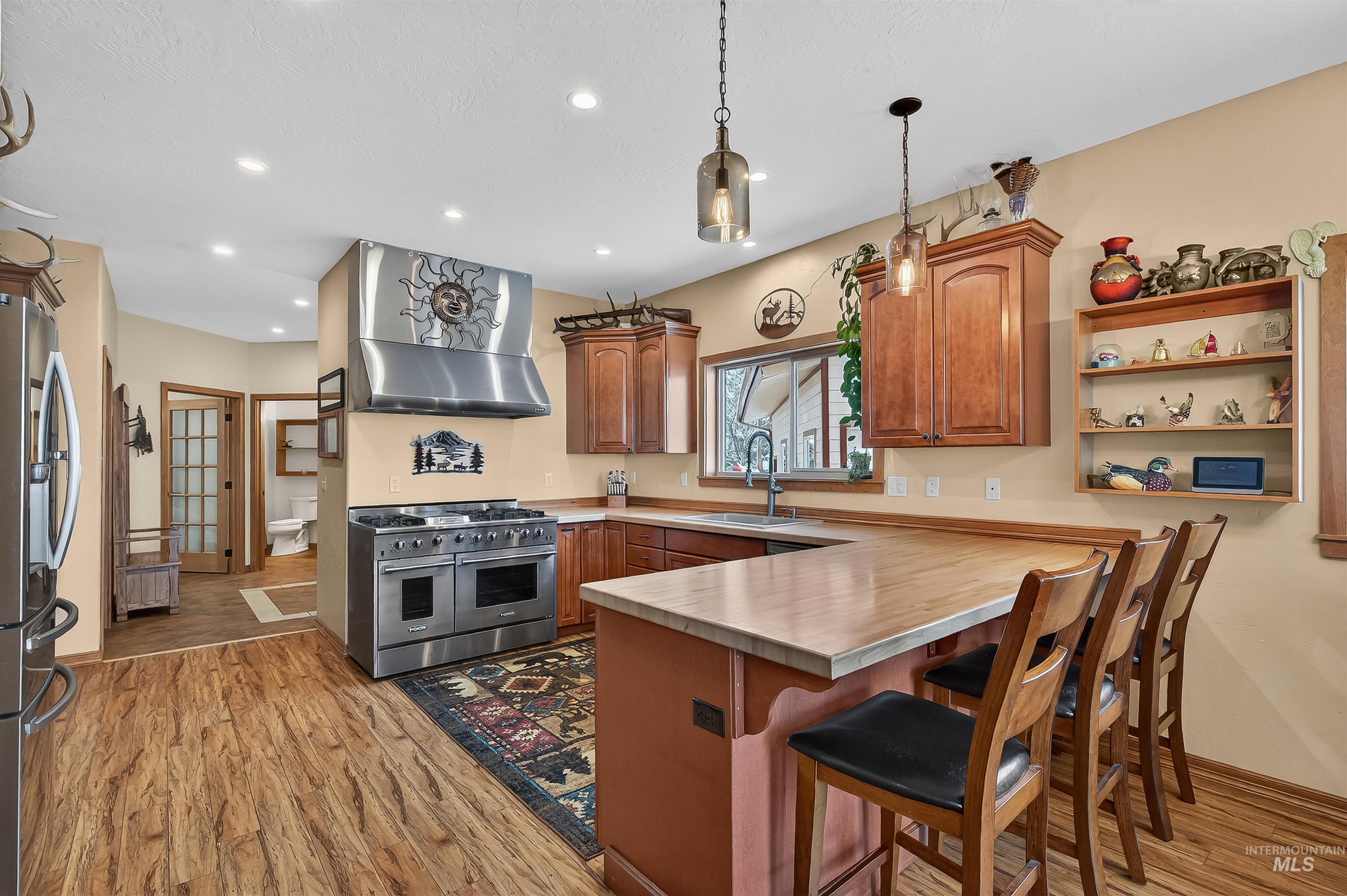 204 South 2nd Street Elk River, ID 83827 - Photo 5 of 50 Commercial gas range, butcher block countertops, breakfast bar, stainless appliances.