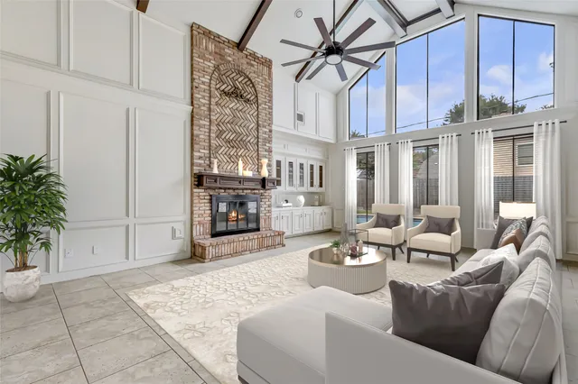 a living room with furniture a fireplace and a potted plant