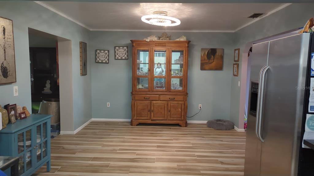 1692 West Salinas Road Avon Park, FL 33825 - Photo 3 of 13 a bedroom with a bed and wooden floor