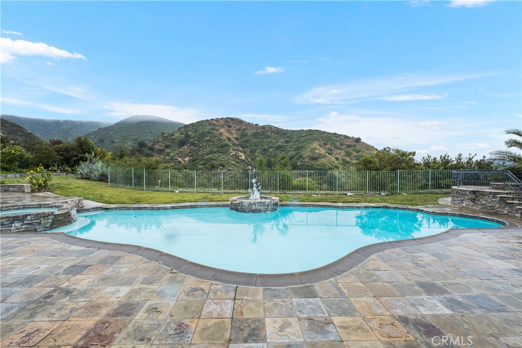 a view of a swimming pool with a lake view and mountain view