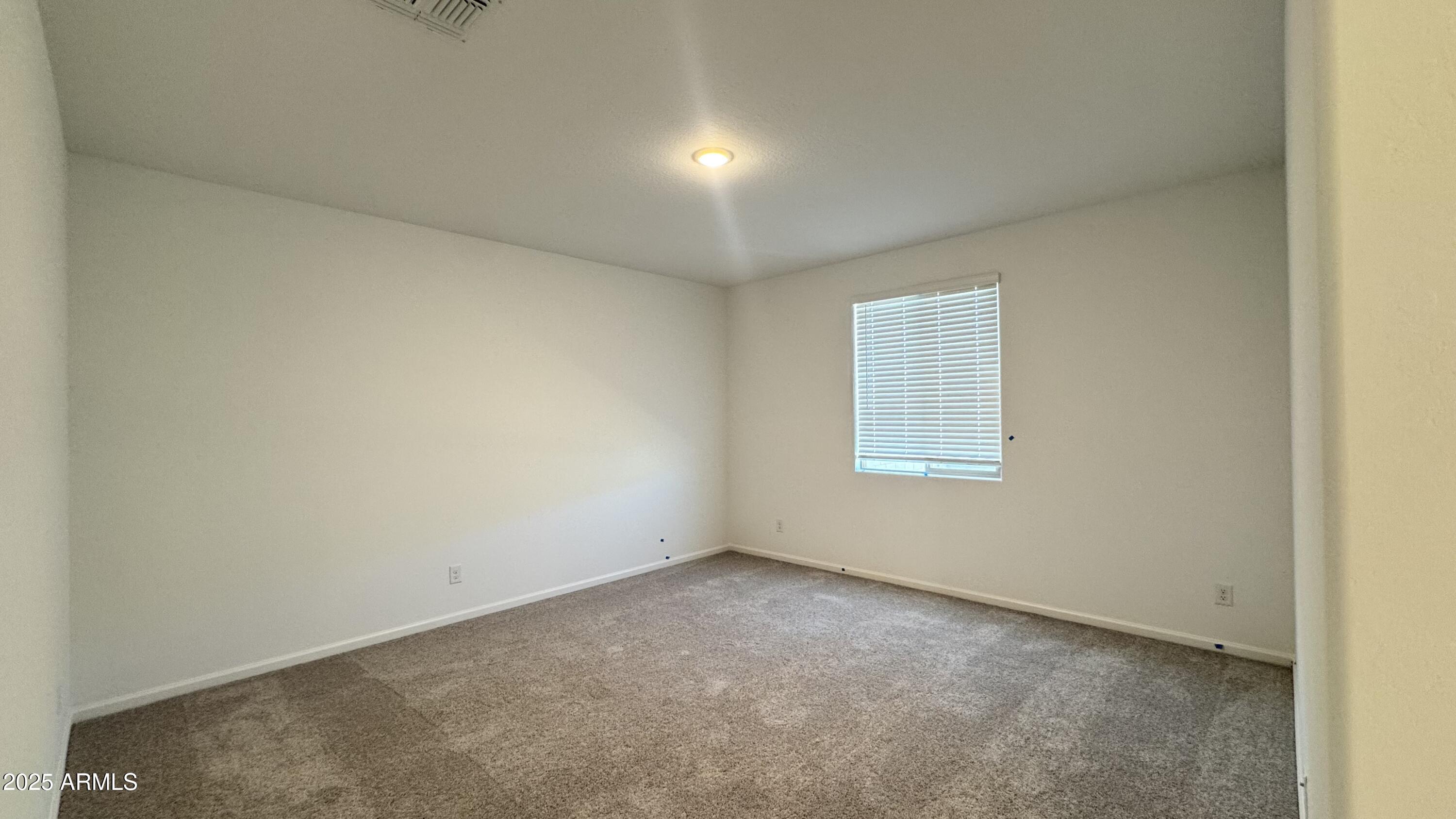 15748 West Camden Avenue Waddell, AZ 85355 - Photo 14 of 36 an empty room with a window