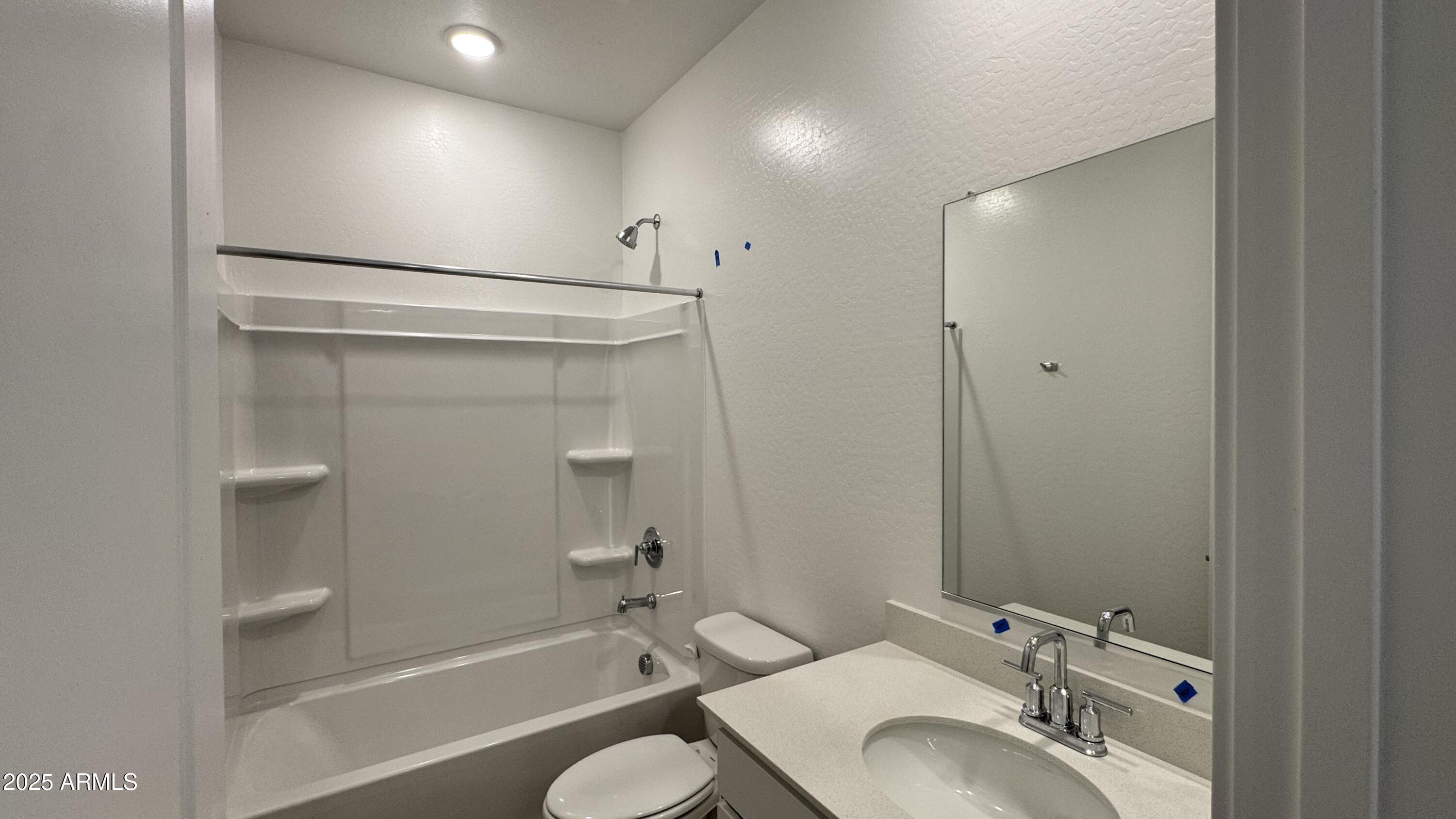 15748 West Camden Avenue Waddell, AZ 85355 - Photo 4 of 36 a bathroom with a granite countertop sink toilet and shower