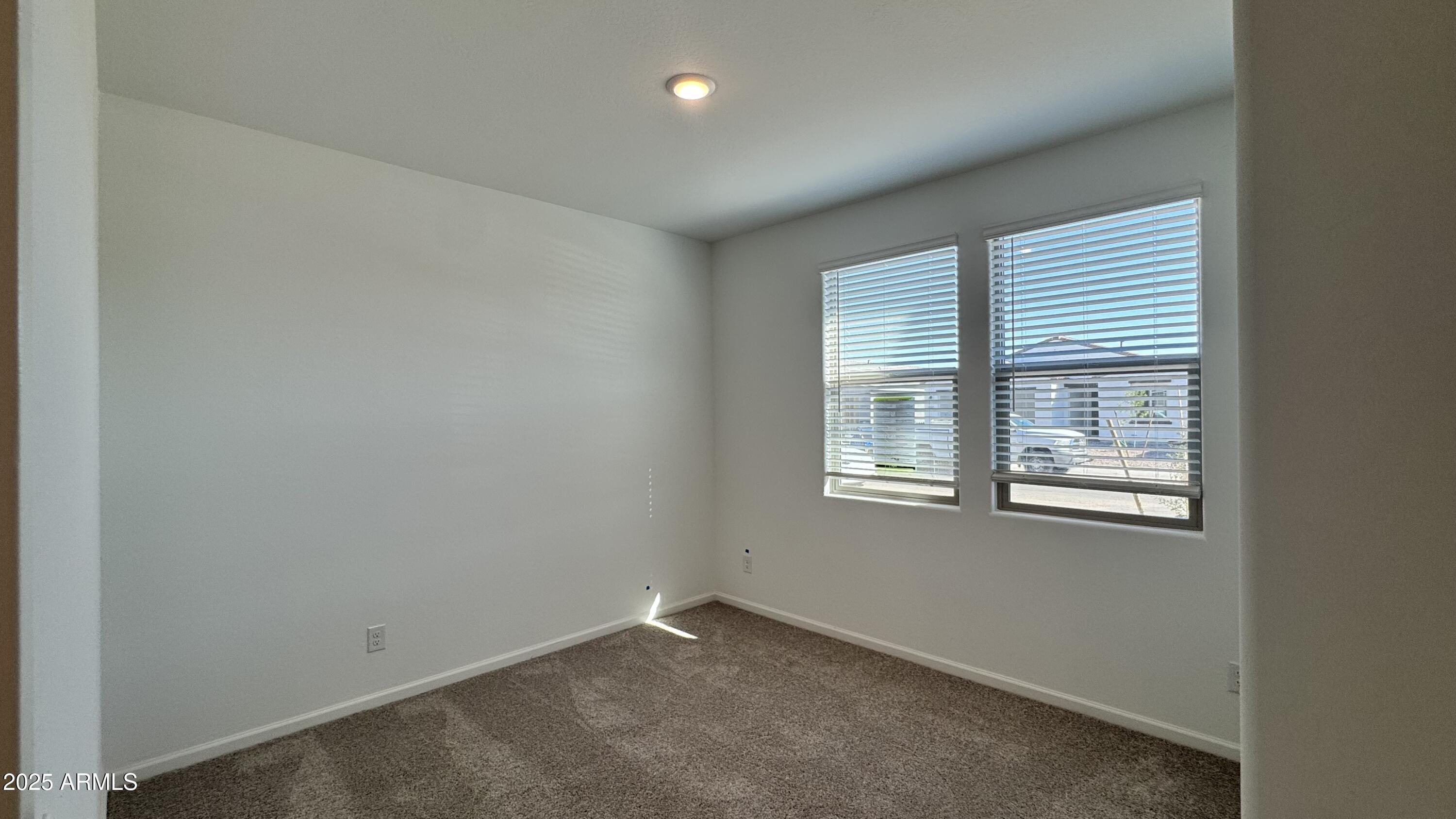 15748 West Camden Avenue Waddell, AZ 85355 - Photo 5 of 36 an empty room with a window