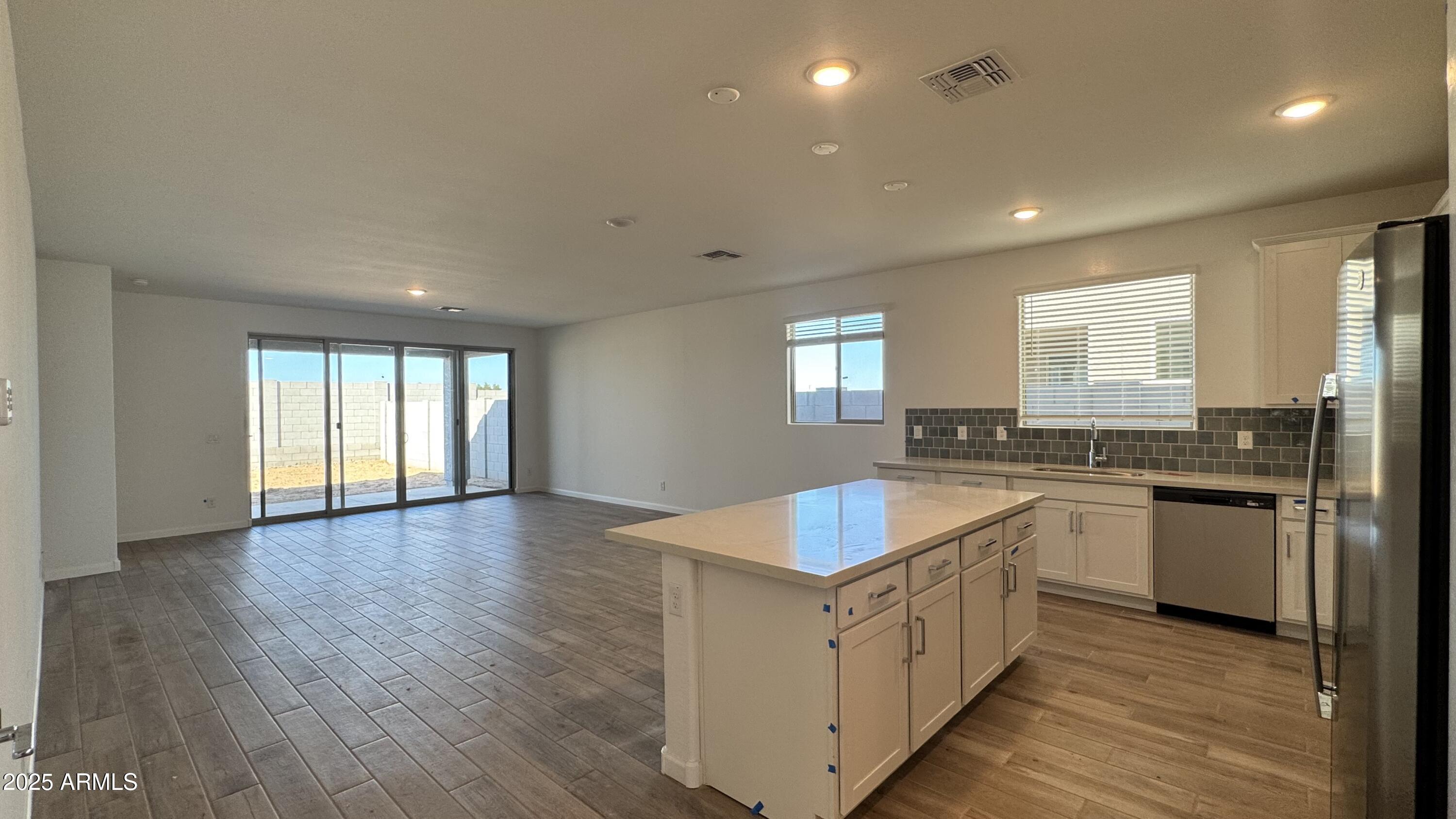 15748 West Camden Avenue Waddell, AZ 85355 - Photo 7 of 36 a kitchen with sink stove and refrigerator