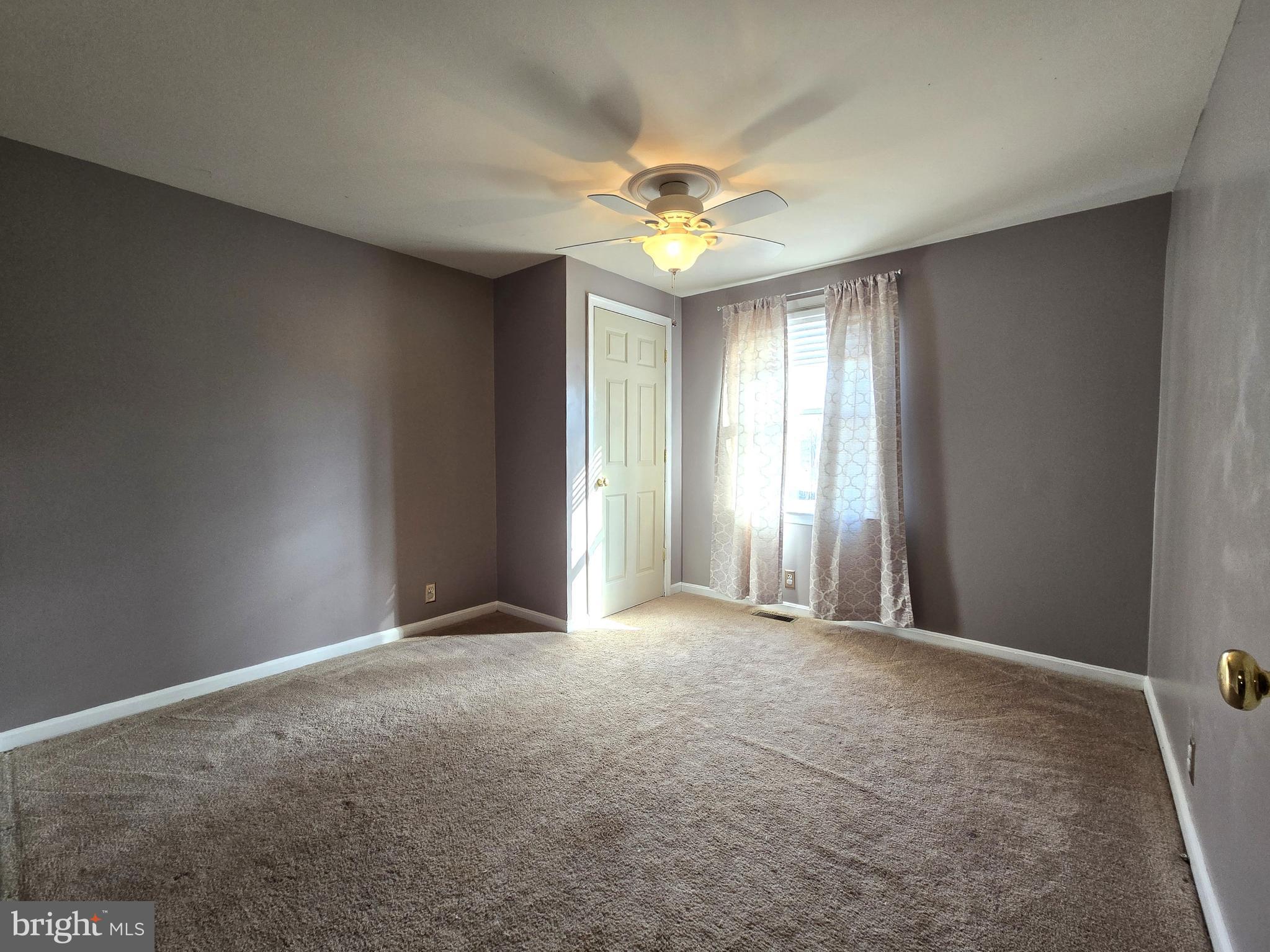 803 Tomahawk Trail Winchester, VA 22602 - Photo 16 of 20 a view of a big room with windows and chandelier fan