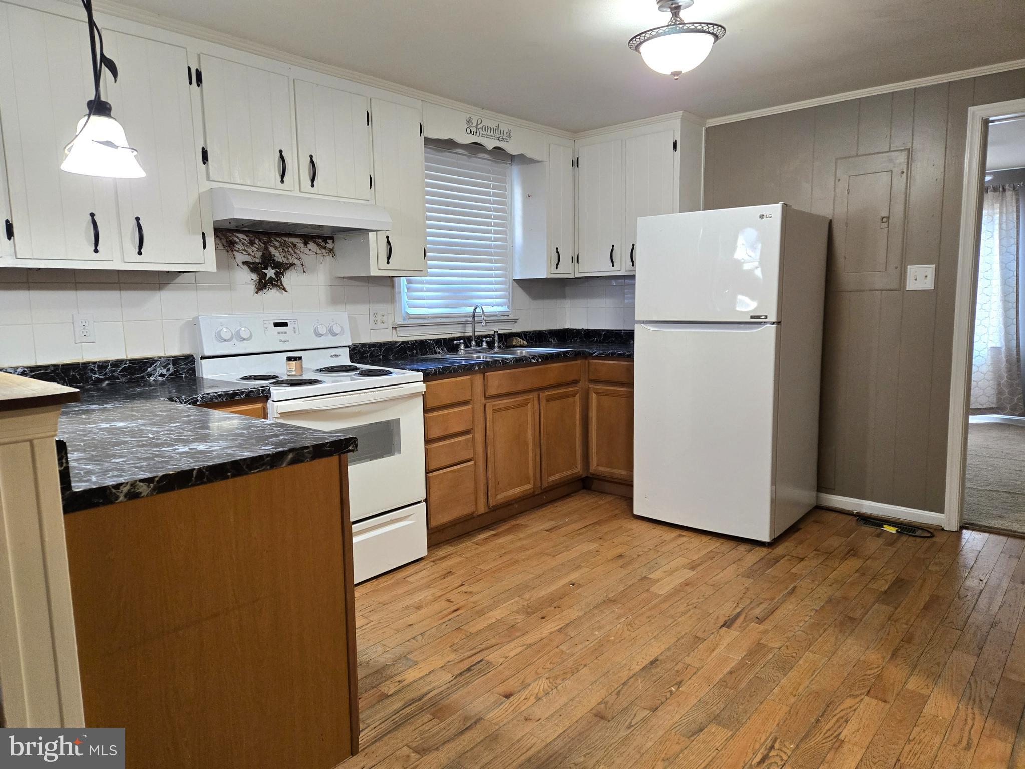 803 Tomahawk Trail Winchester, VA 22602 - Photo 6 of 20 a kitchen with stainless steel appliances granite countertop a refrigerator a sink a stove and white cabinets