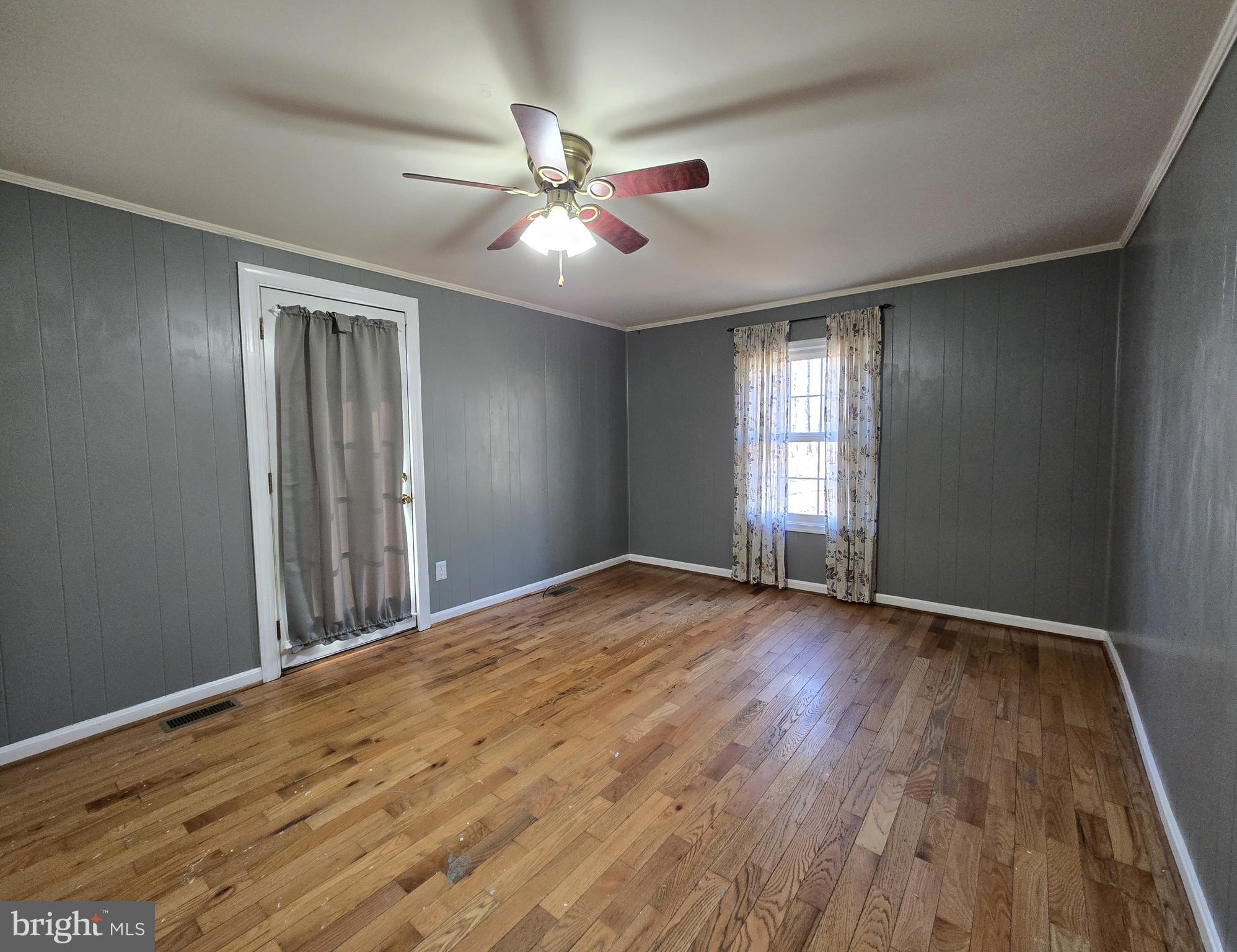 803 Tomahawk Trail Winchester, VA 22602 - Photo 9 of 20 a view of an empty room with wooden floor and a window