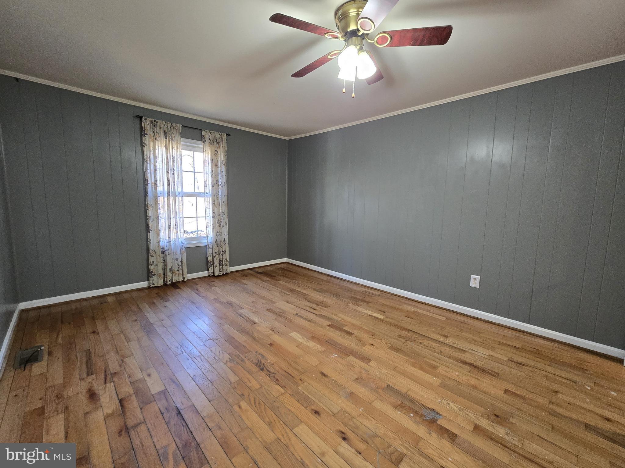 803 Tomahawk Trail Winchester, VA 22602 - Photo 10 of 20 an empty room with wooden floor fan and windows