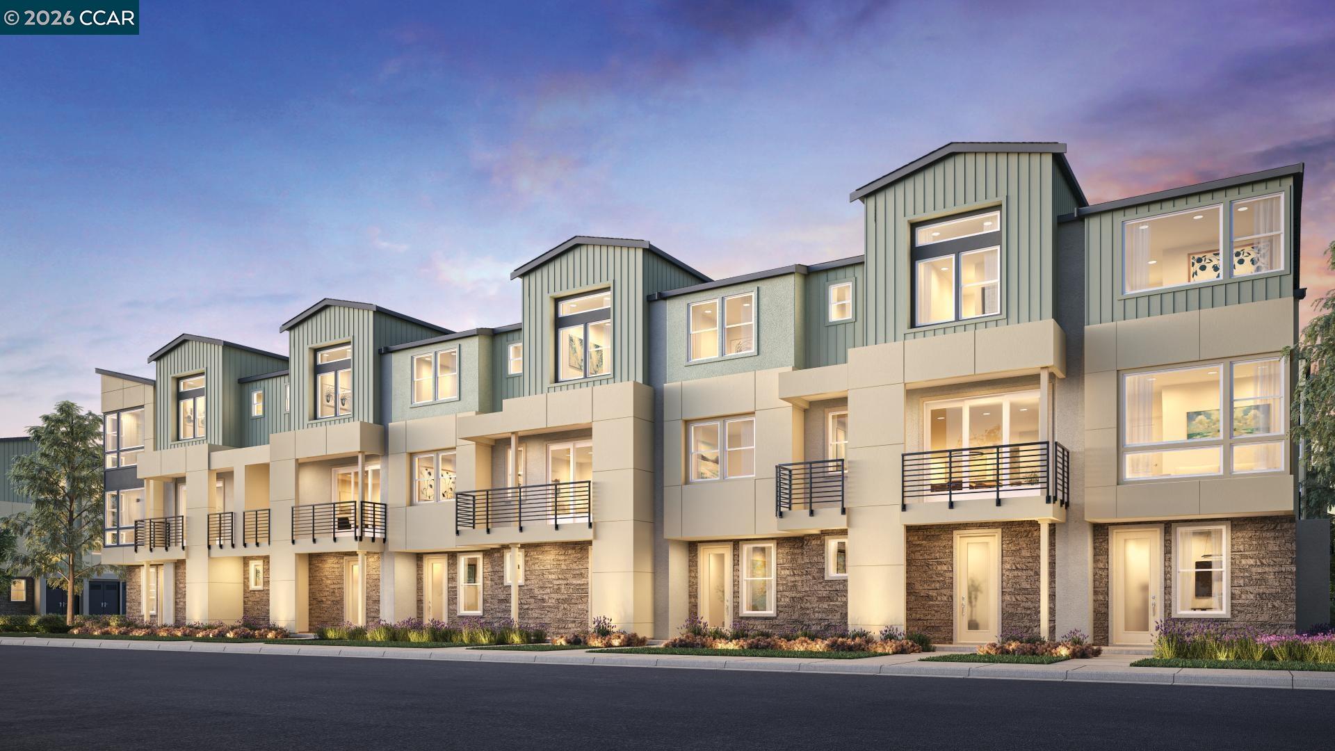 648 South Main Street Milpitas, CA 95035 - Photo 15 of 17 a front view of a residential apartment building with a yard