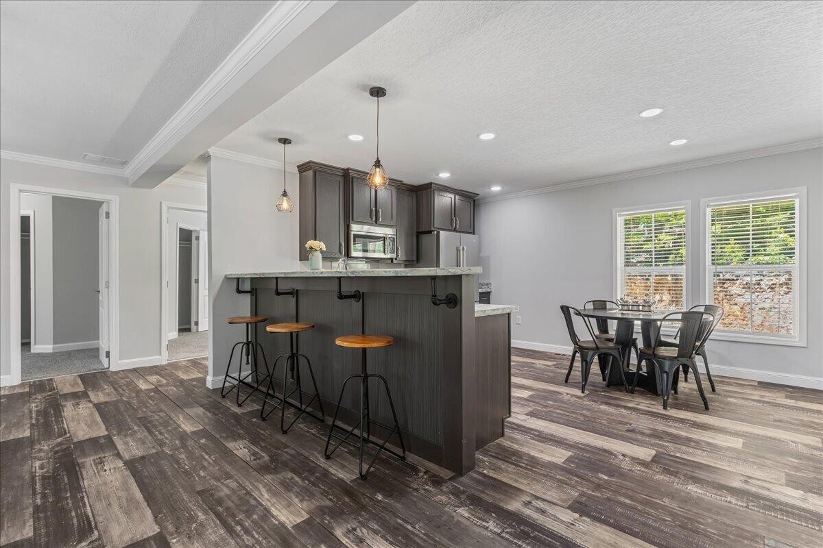 1629 Wasson Road Ten Mile, TN 37880 - Photo 13 of 27 a kitchen with stainless steel appliances granite countertop a table chairs and a refrigerator