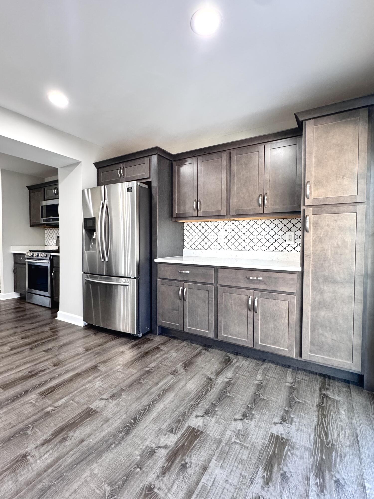 3429 42nd Street Highland, IN 46322 - Photo 12 of 42 a kitchen with granite countertop a refrigerator and a sink