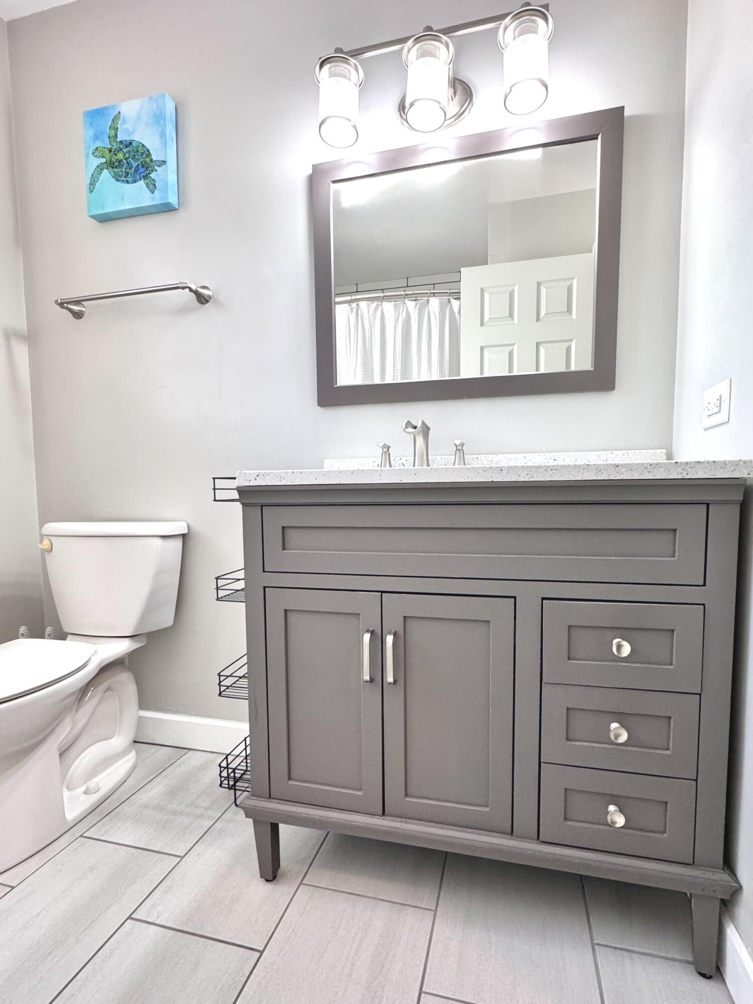 3429 42nd Street Highland, IN 46322 - Photo 15 of 42 a bathroom with a toilet a sink and mirror
