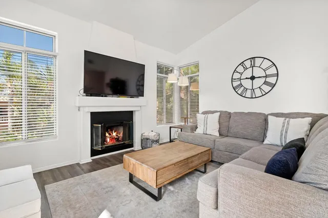a living room with furniture and view of kitchen
