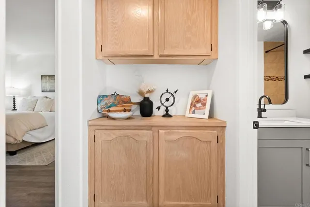 a bedroom with a bed and a flat tv screen on dresser