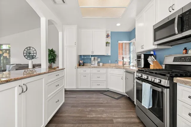 a kitchen with stainless steel appliances granite countertop a stove and a sink