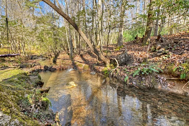 a view of yard with swimming pool and sitting area