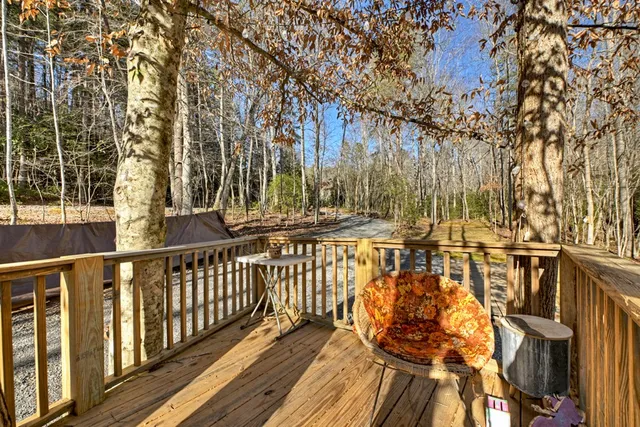 a view of a backyard with table and chairs under an umbrella