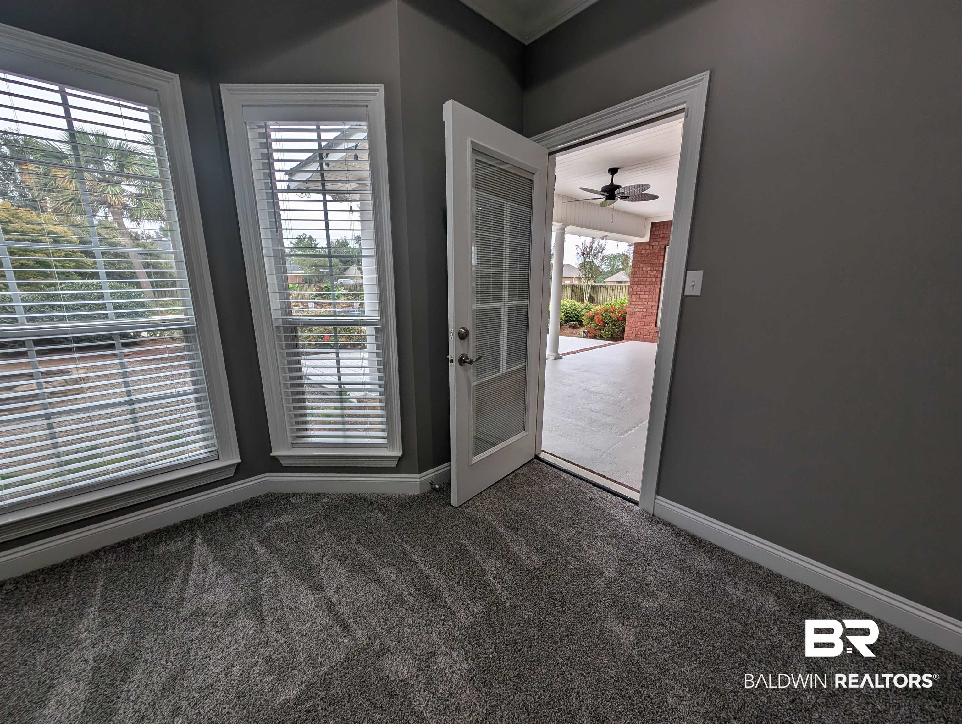11623 Halcyon Loop Daphne, AL 36526 - Photo 56 of 90 Master bedroom patio door featuring a healthy amount of sunlight and colorful views from the back yard.