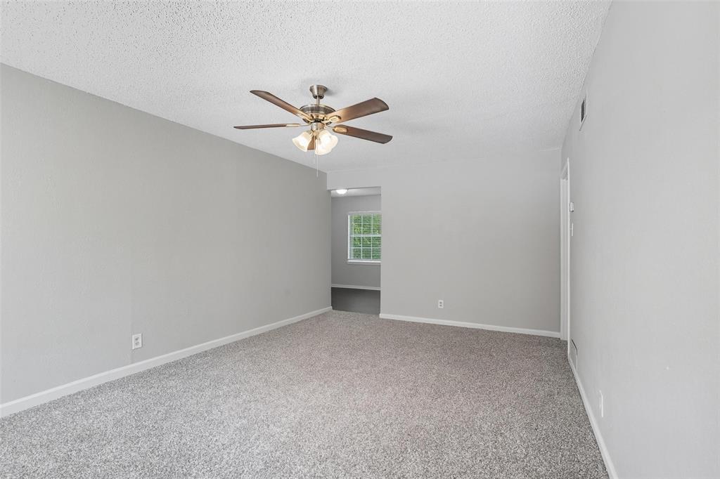 3211 Gus Thomasson Road Dallas, TX 75228 - Photo 4 of 23 an empty room with a window and a fan