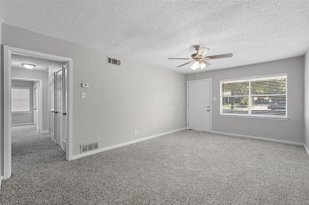 3211 Gus Thomasson Road Dallas, TX 75228 - Photo 5 of 23 an empty room with chandelier fan and windows