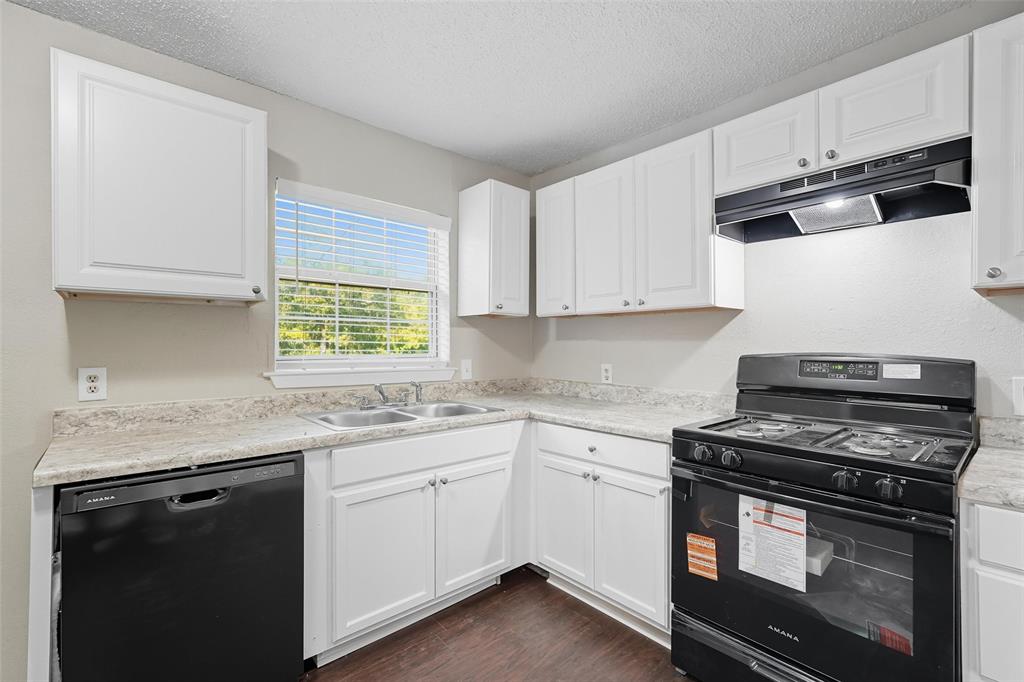 3211 Gus Thomasson Road Dallas, TX 75228 - Photo 7 of 23 a kitchen with appliances cabinets and a window