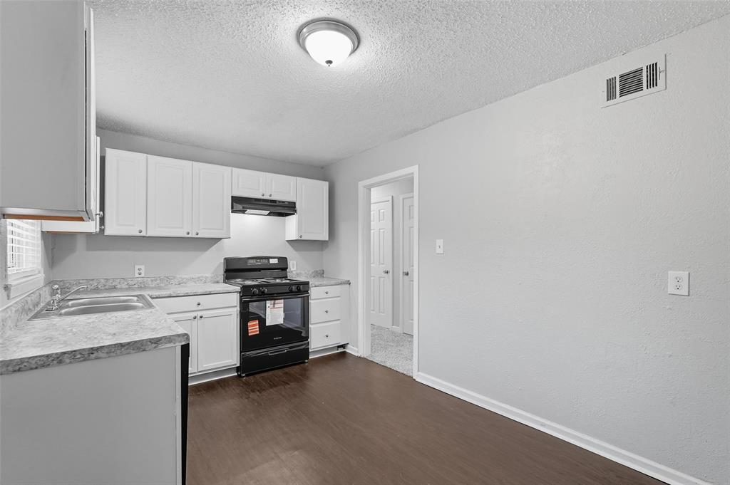 3211 Gus Thomasson Road Dallas, TX 75228 - Photo 9 of 23 a kitchen with stainless steel appliances granite countertop a stove and a refrigerator
