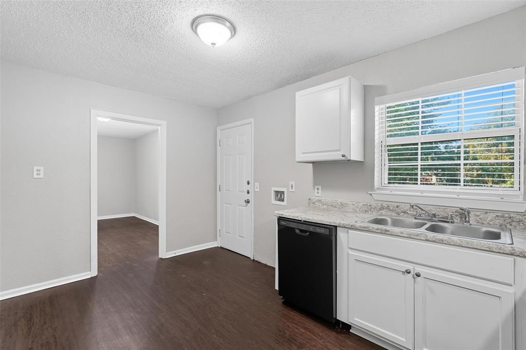 3211 Gus Thomasson Road Dallas, TX 75228 - Photo 10 of 23 a kitchen with a sink cabinets and window