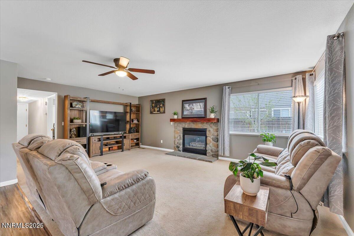 55 Ghost Rider Court Reno, NV 89511 - Photo 11 of 29 a living room with furniture a fireplace and a flat screen tv