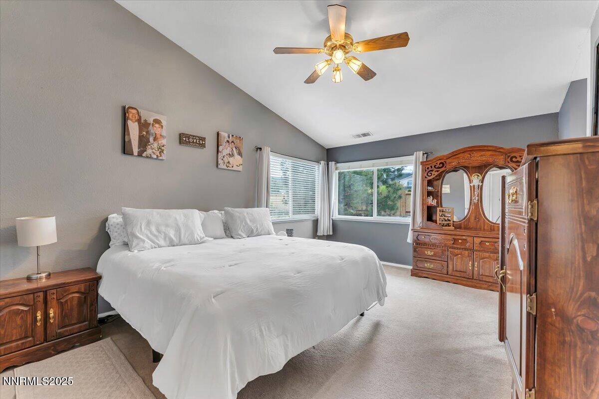 55 Ghost Rider Court Reno, NV 89511 - Photo 15 of 29 a bedroom with a bed and a chandelier