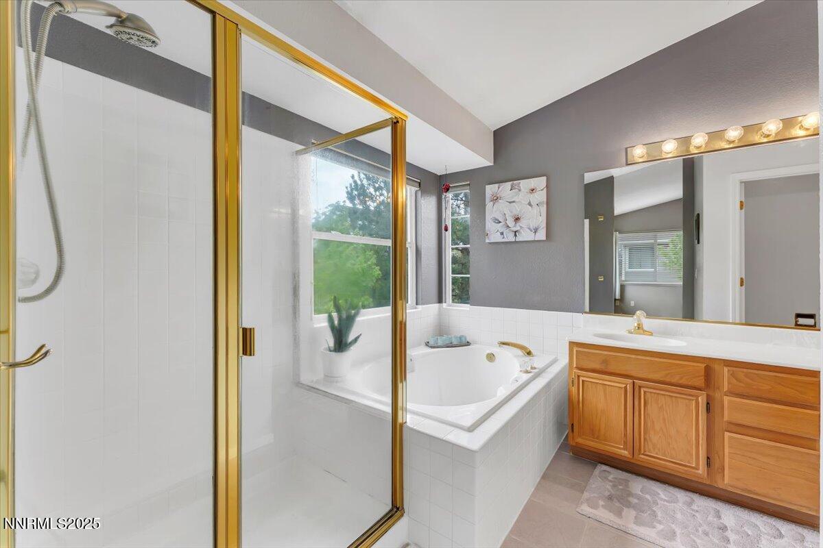 55 Ghost Rider Court Reno, NV 89511 - Photo 16 of 29 a bathroom with a tub sink and mirror