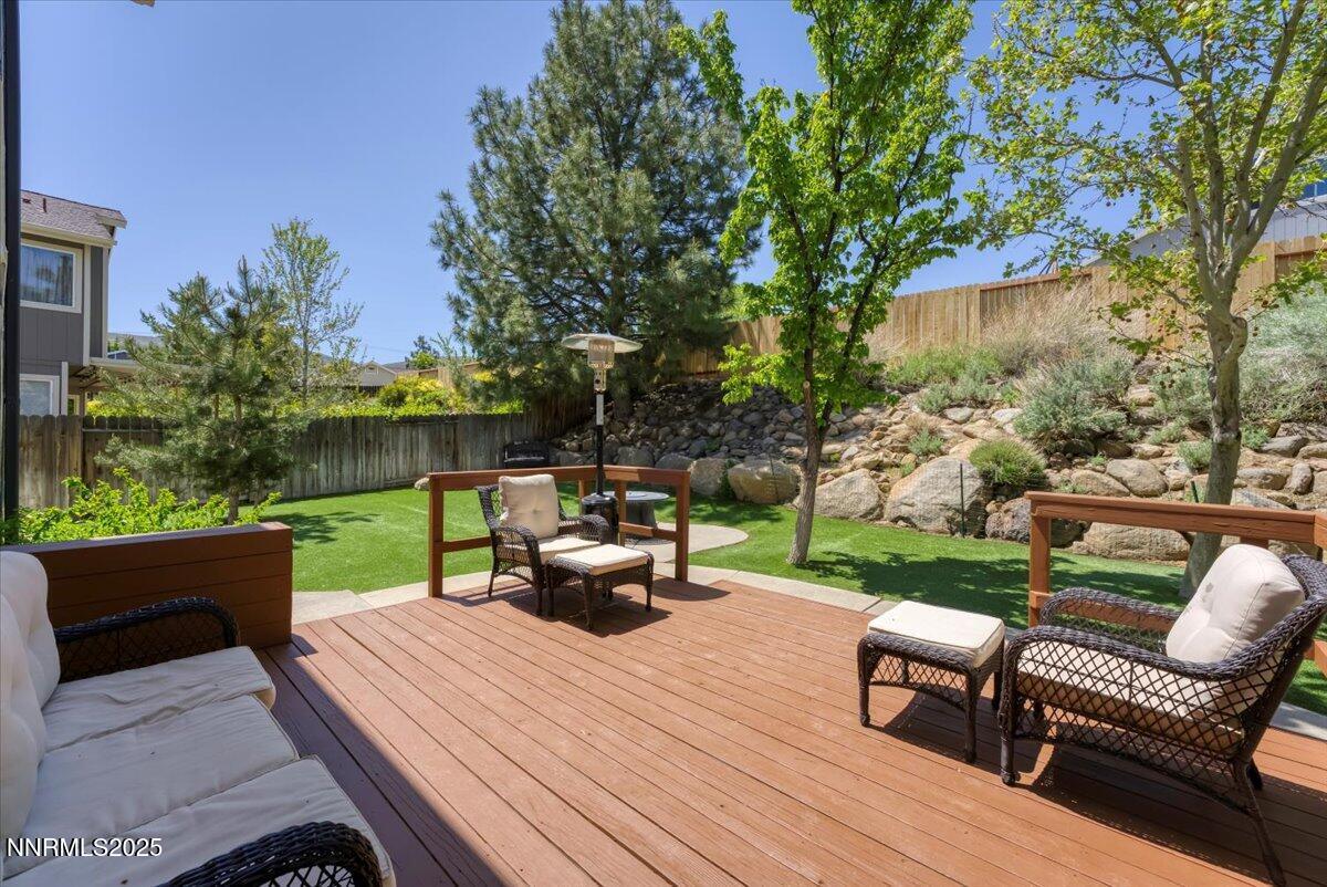 55 Ghost Rider Court Reno, NV 89511 - Photo 22 of 29 a view of a patio with couches table and chairs with wooden fence and plants