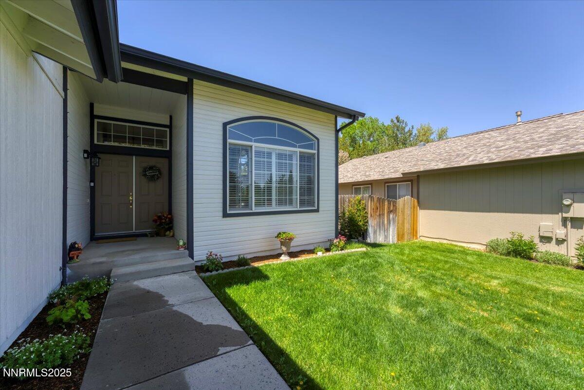 55 Ghost Rider Court Reno, NV 89511 - Photo 3 of 29 a front view of a house with garden
