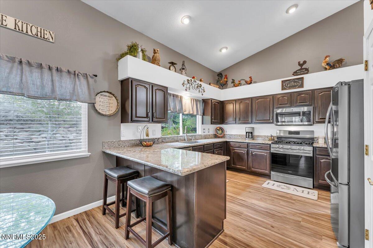 55 Ghost Rider Court Reno, NV 89511 - Photo 9 of 29 a kitchen with stainless steel appliances granite countertop a sink stove and refrigerator