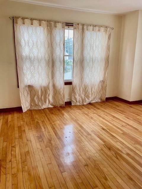 259 Massasoit Road Worcester, MA 01604 - Photo 13 of 23 a view of an empty room with wooden floor and a window