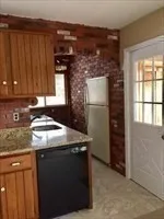 a kitchen with a sink a refrigerator and window