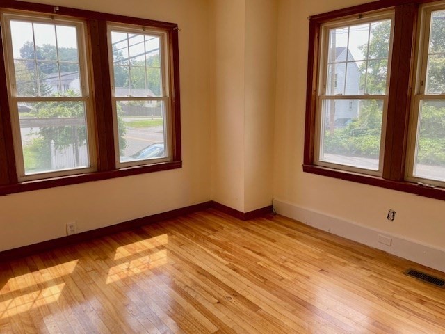 259 Massasoit Road Worcester, MA 01604 - Photo 21 of 23 a view of an empty room with wooden floor and a window