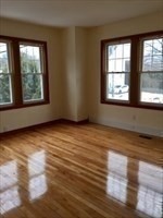 259 Massasoit Road Worcester, MA 01604 - Photo 6 of 23 an empty room with wooden floor and windows