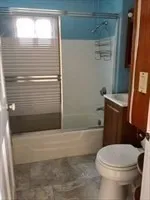 a bathroom with a toilet and a bathtub