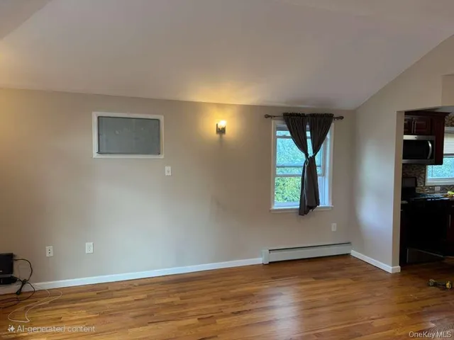 a view of wooden floor and windows in a room