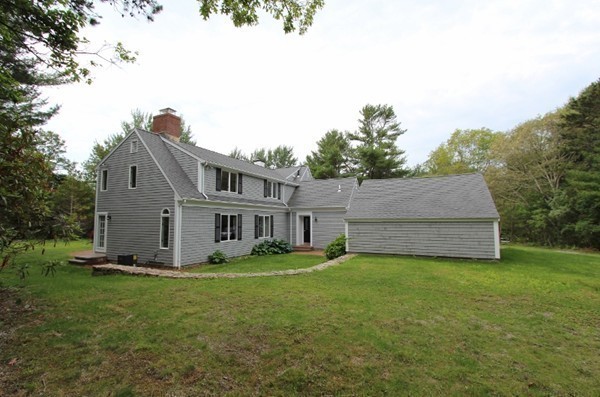 1500 South County Road Barnstable, MA 02655 - Photo 30 of 30 a house that is sitting in the grass with large trees