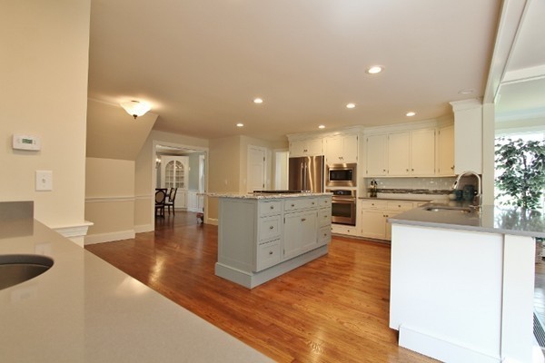 1500 South County Road Barnstable, MA 02655 - Photo 8 of 30 a large kitchen with white cabinets and stainless steel appliances