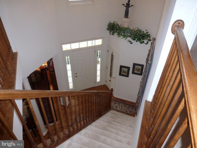 1999 Long Corner Road Mount Airy, MD 21771 - Photo 1 of 27 a view of a hallway with wooden floor and stairs