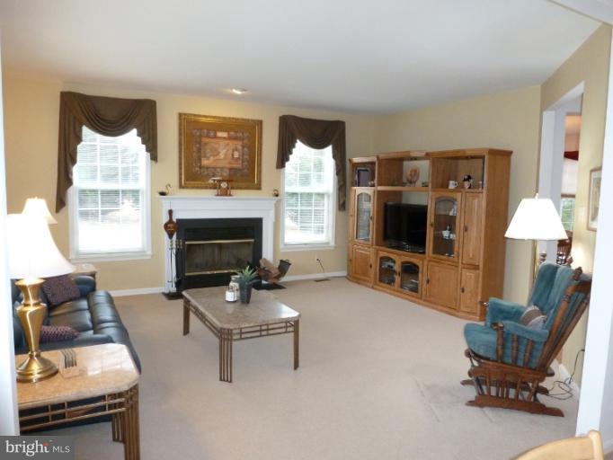 1999 Long Corner Road Mount Airy, MD 21771 - Photo 4 of 27 a living room with furniture a flat screen tv and a fireplace