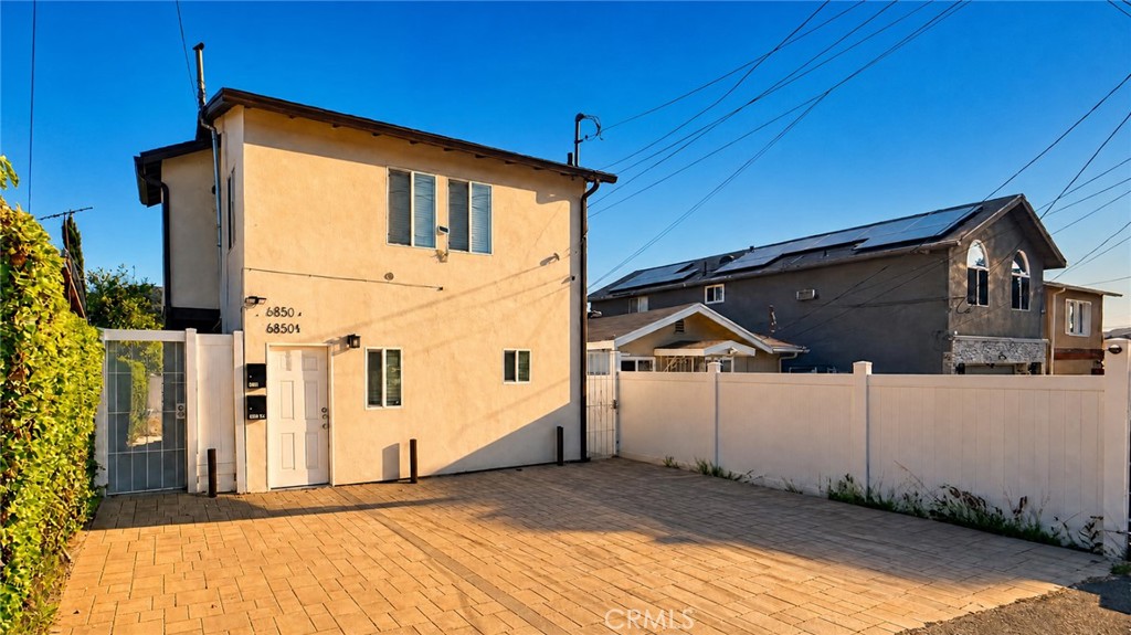 6851 Foothill Boulevard Tujunga, CA 91042 - Photo 32 of 50 a front view of a house with garage